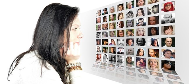Woman looking at remote participants on a computer screen.